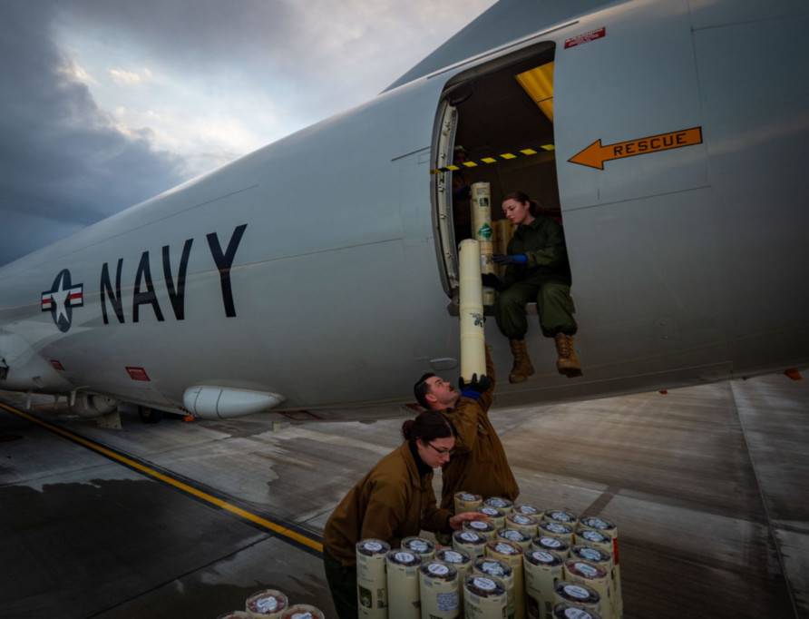 RAF LOSSIEMOUTH, Scotland (Dec. 14, 2020) Aircrew Survival Equipmentman 3rd Class Alyssa Kozak, left, Hospital Corpsman 2nd Class Austin Phillips, center, and Aviation Ordnanceman Airman Siane Nash assigned to the 